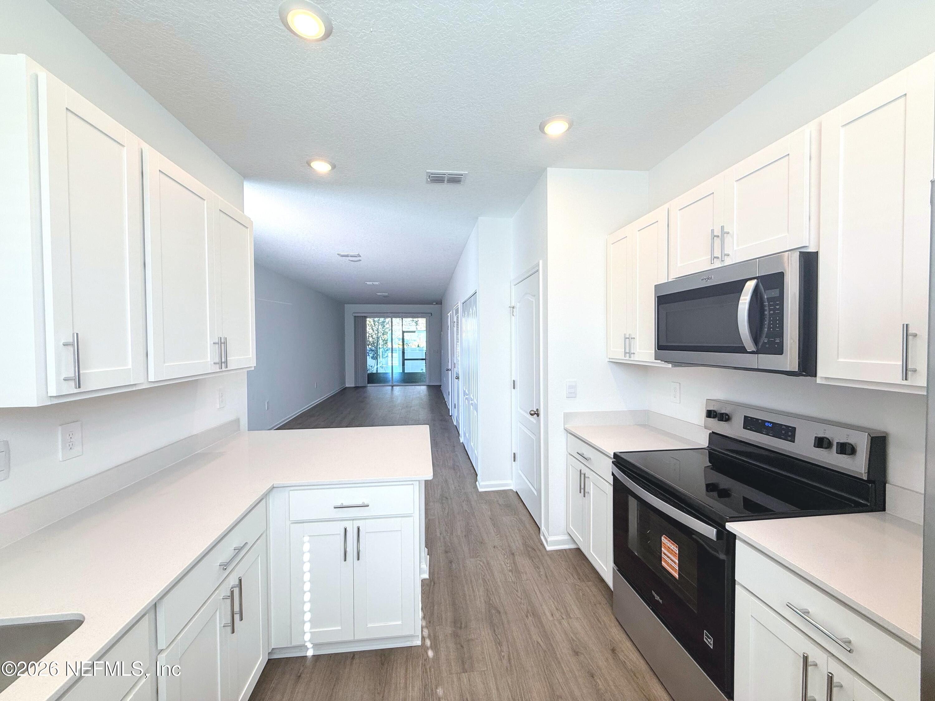 131 Palmetto Rdg Road St. Augustine, FL 32095 - Photo 8 of 22 a kitchen with granite countertop a sink and a stove top oven