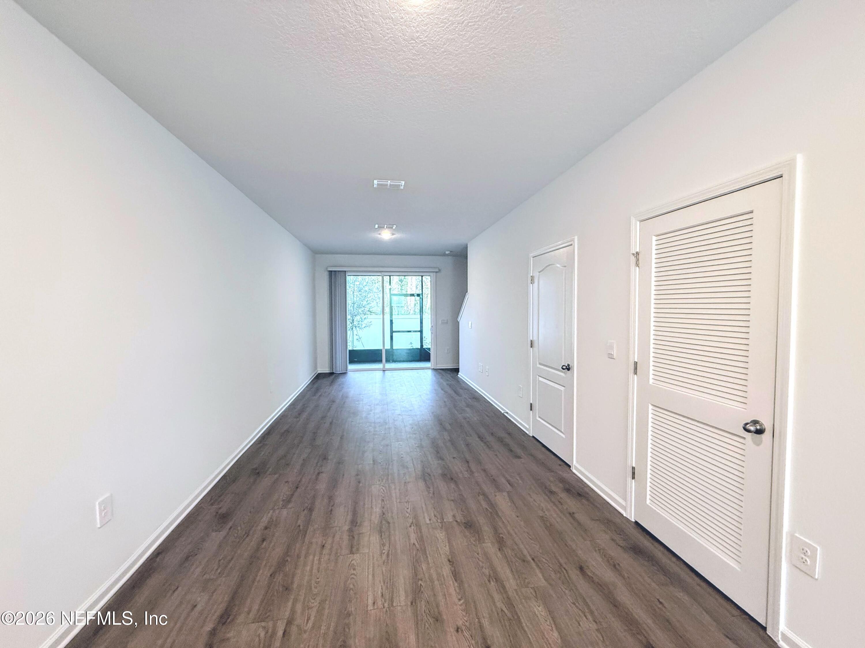 131 Palmetto Rdg Road St. Augustine, FL 32095 - Photo 9 of 22 a view of an empty room with wooden floor and a window