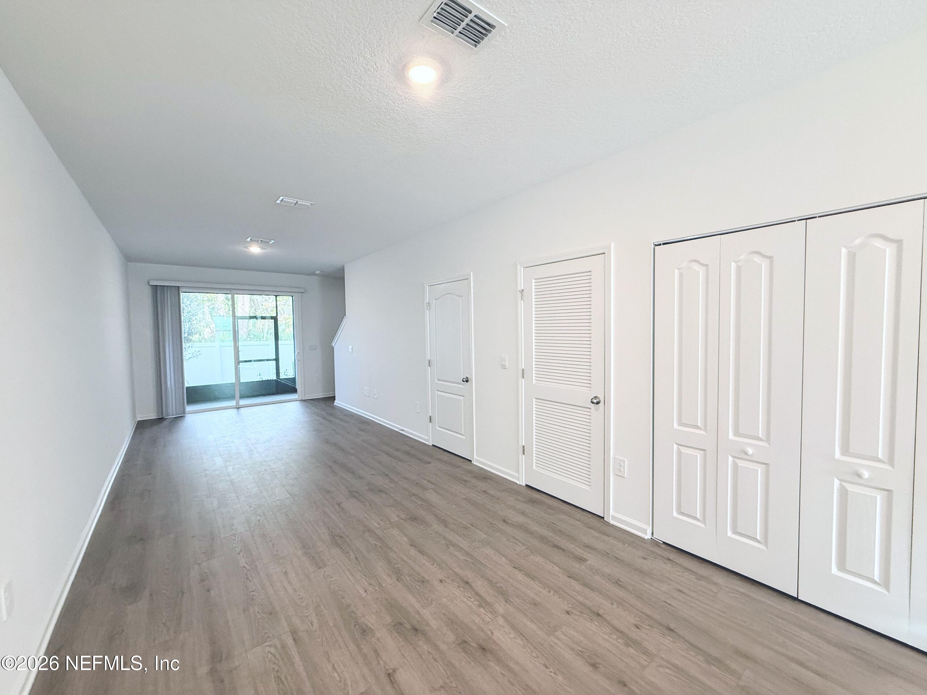 131 Palmetto Rdg Road St. Augustine, FL 32095 - Photo 10 of 22 a view of wooden floor and windows in a room