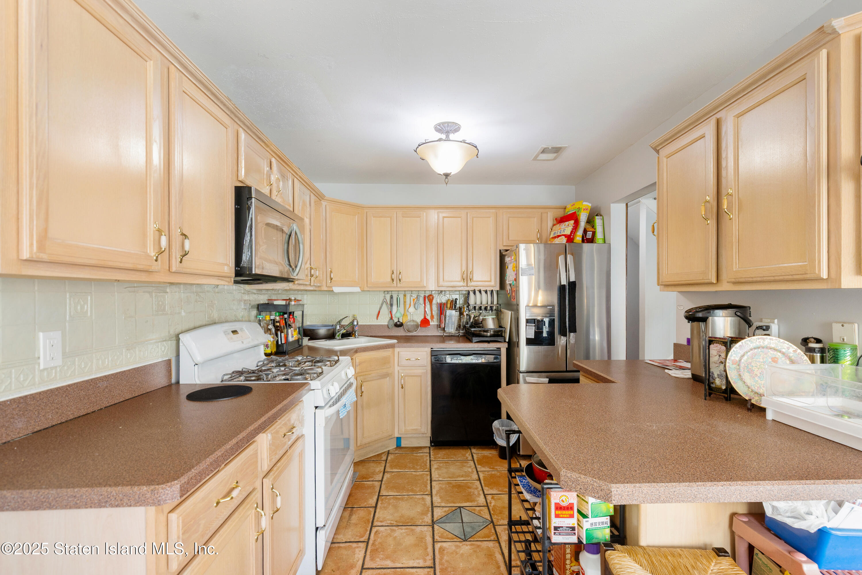 263 Jamie Lane Staten Island, NY 10312 - Photo 20 of 44 a kitchen with a sink stove top oven and cabinets