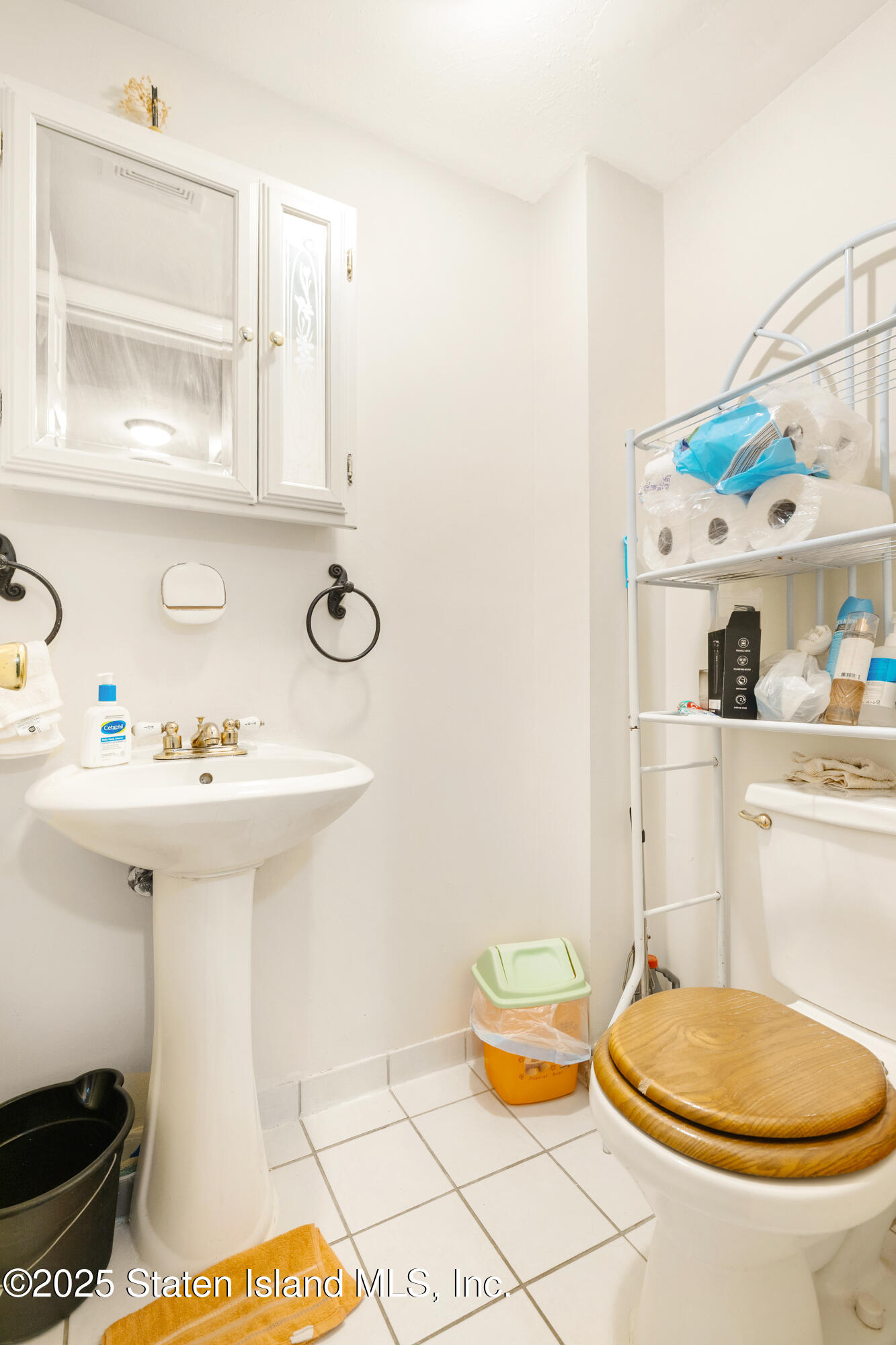263 Jamie Lane Staten Island, NY 10312 - Photo 26 of 44 a bathroom with a sink a toilet and mirror
