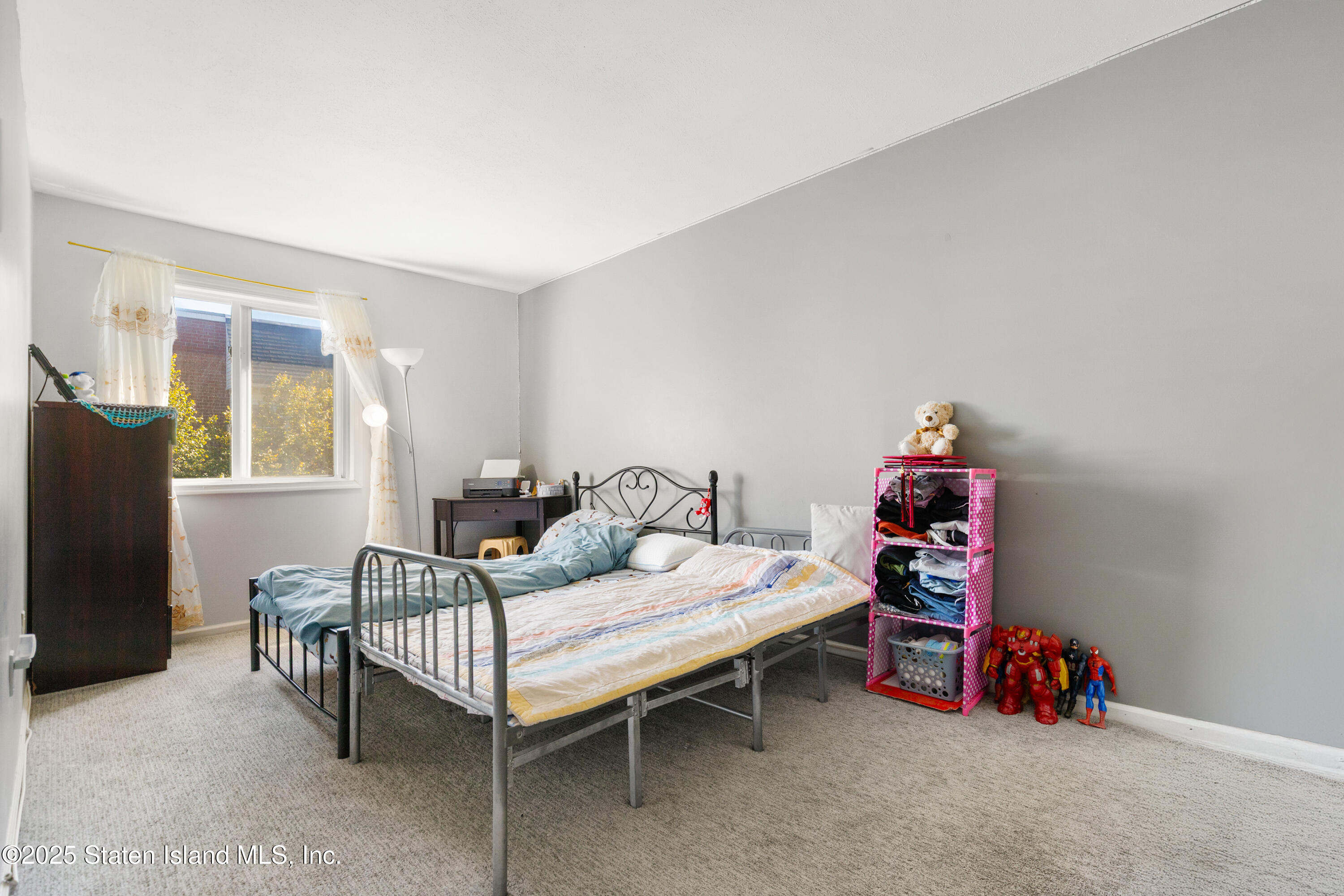 263 Jamie Lane Staten Island, NY 10312 - Photo 29 of 44 a bedroom with furniture and a couch