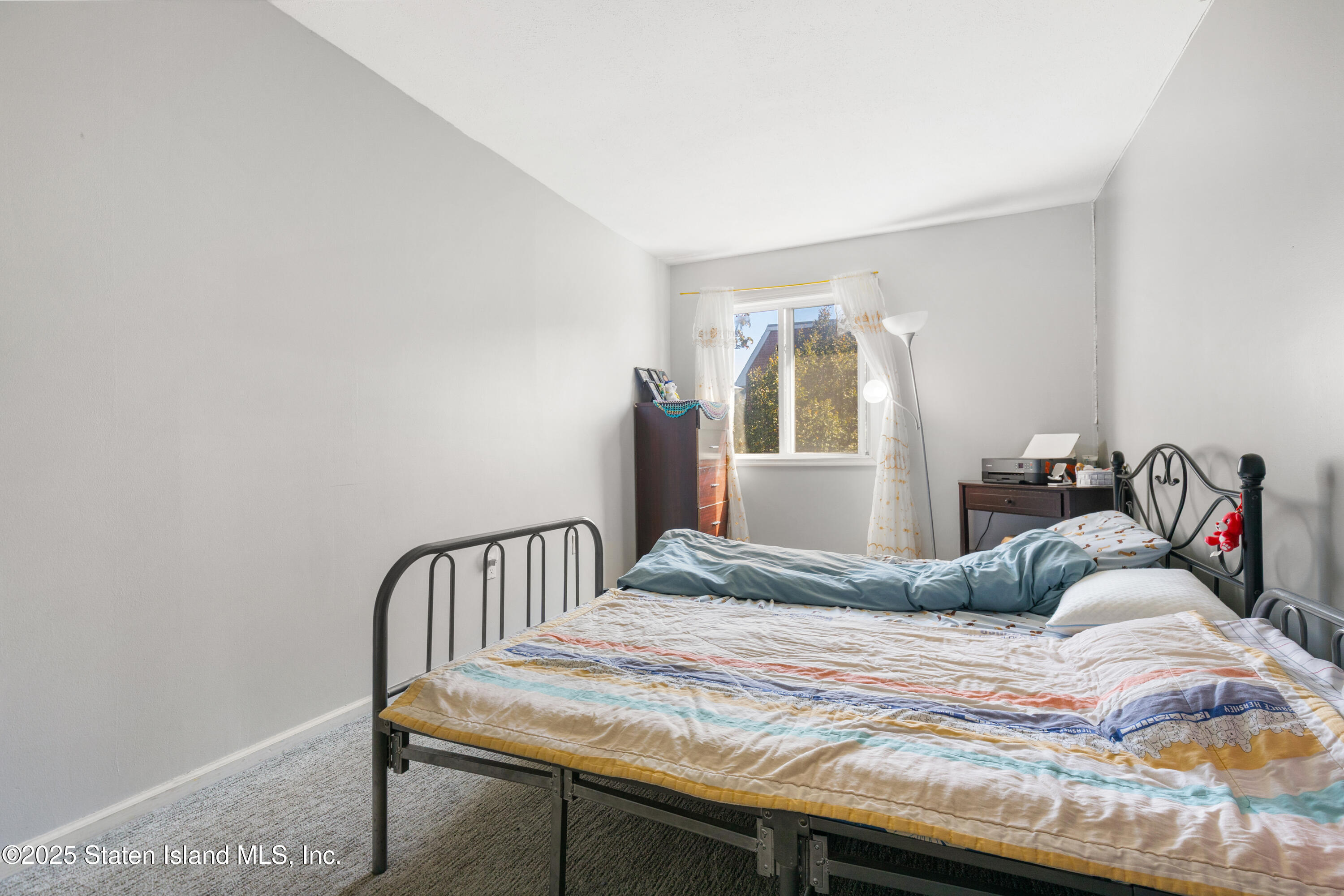 263 Jamie Lane Staten Island, NY 10312 - Photo 30 of 44 a bedroom with a bed and a table