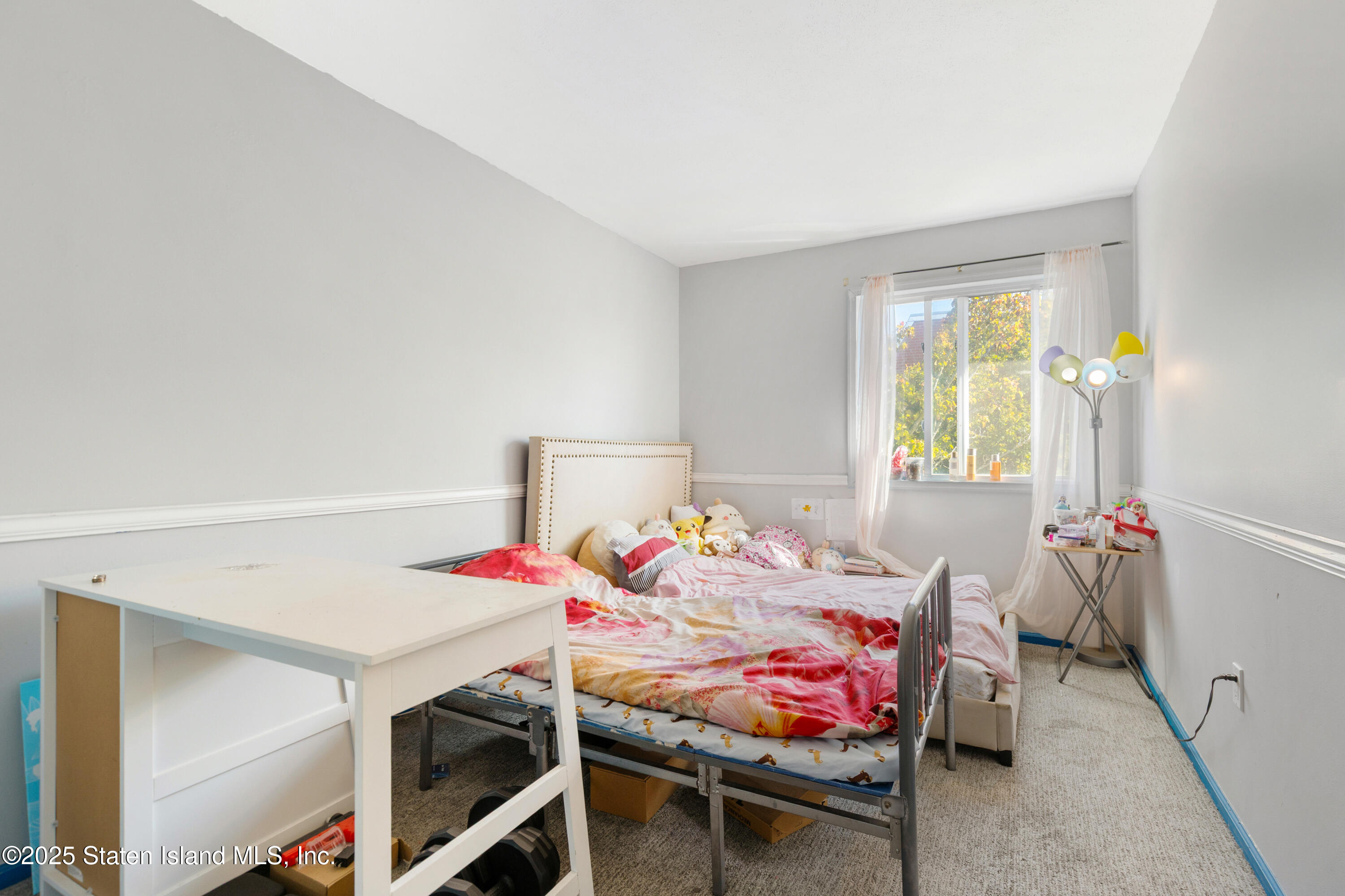 263 Jamie Lane Staten Island, NY 10312 - Photo 33 of 44 a bedroom with a bed and a table