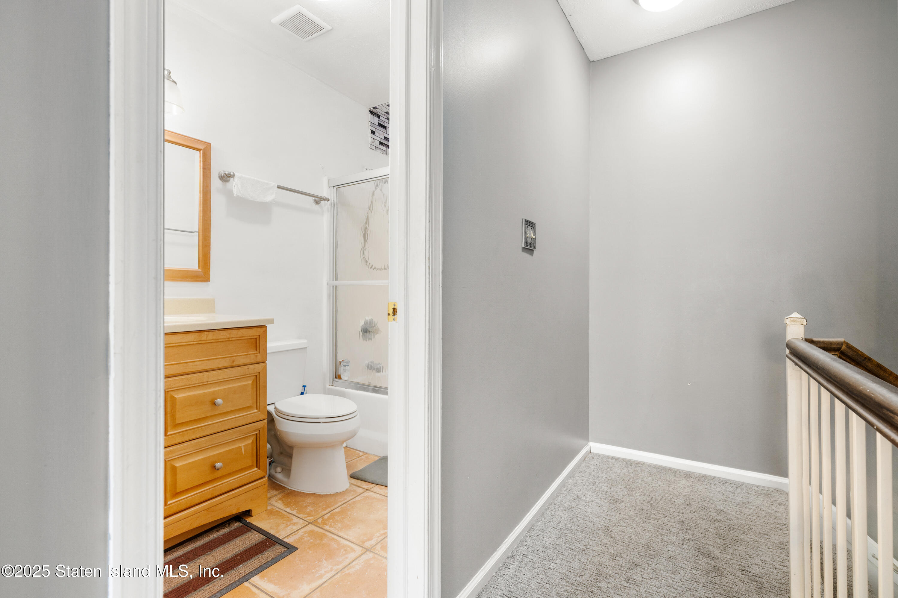 263 Jamie Lane Staten Island, NY 10312 - Photo 36 of 44 a bathroom with a granite countertop toilet and a shower