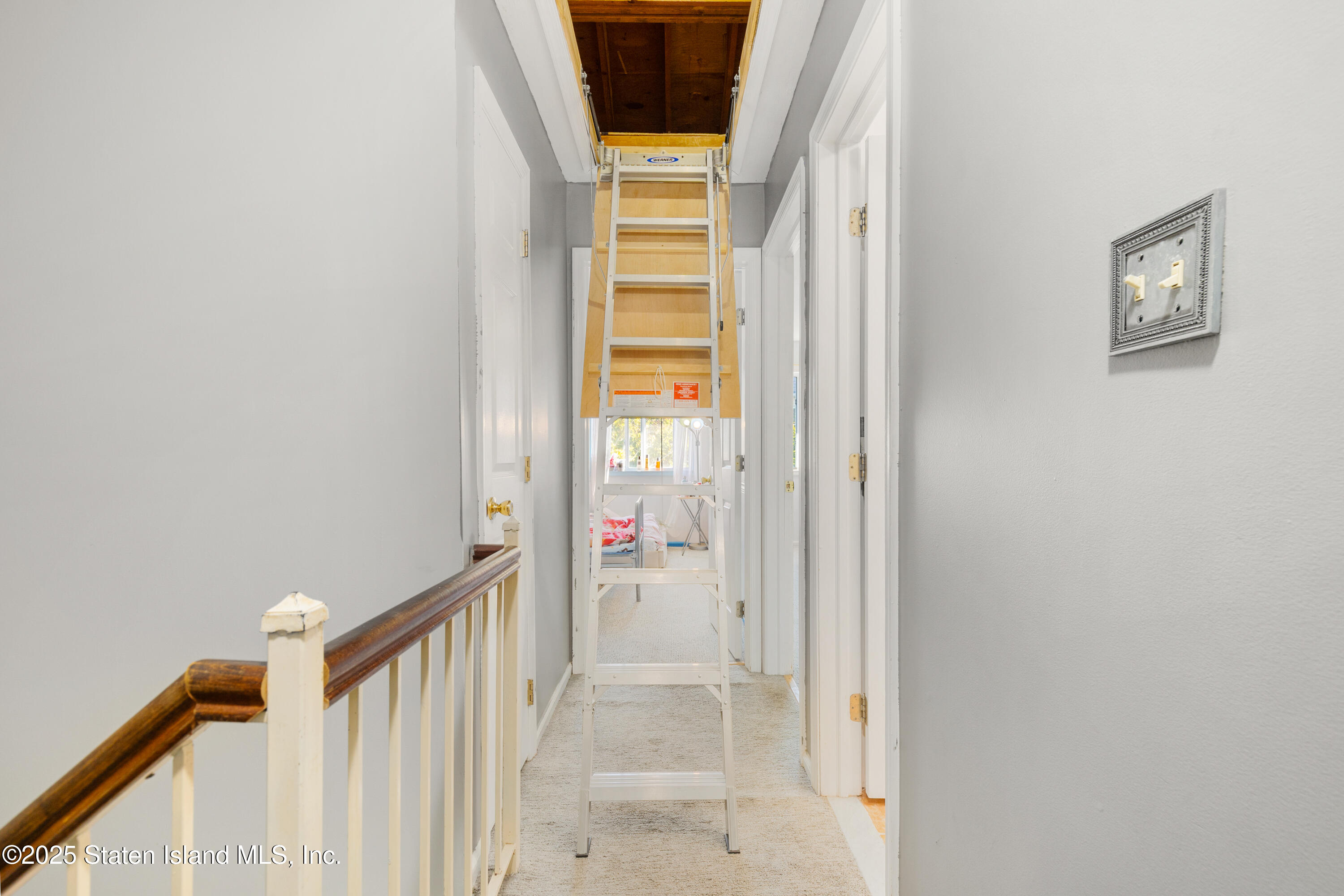 263 Jamie Lane Staten Island, NY 10312 - Photo 38 of 44 a view of a hallway with wooden floor and windows