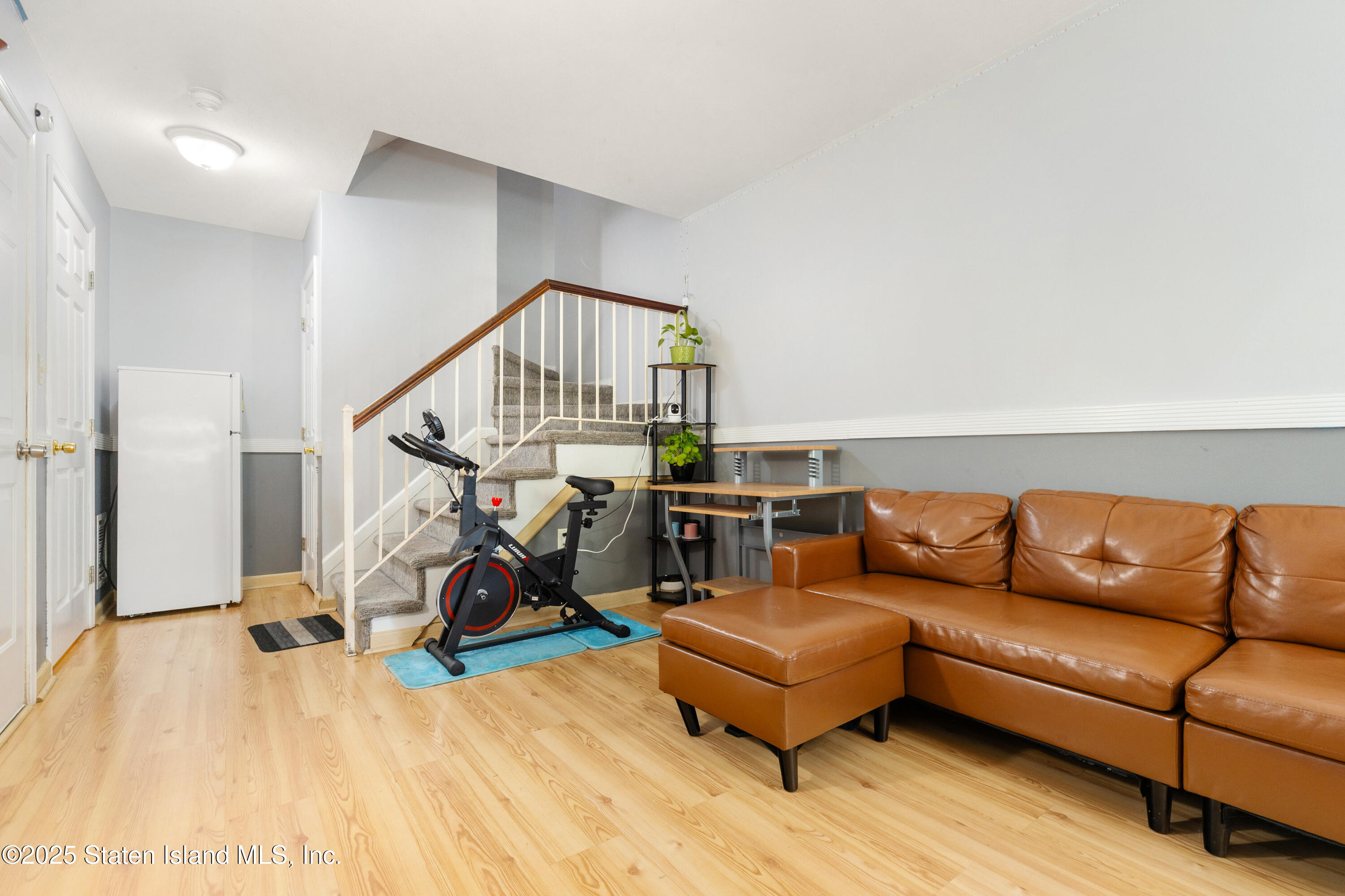263 Jamie Lane Staten Island, NY 10312 - Photo 8 of 44 a living room with furniture a rug and white walls