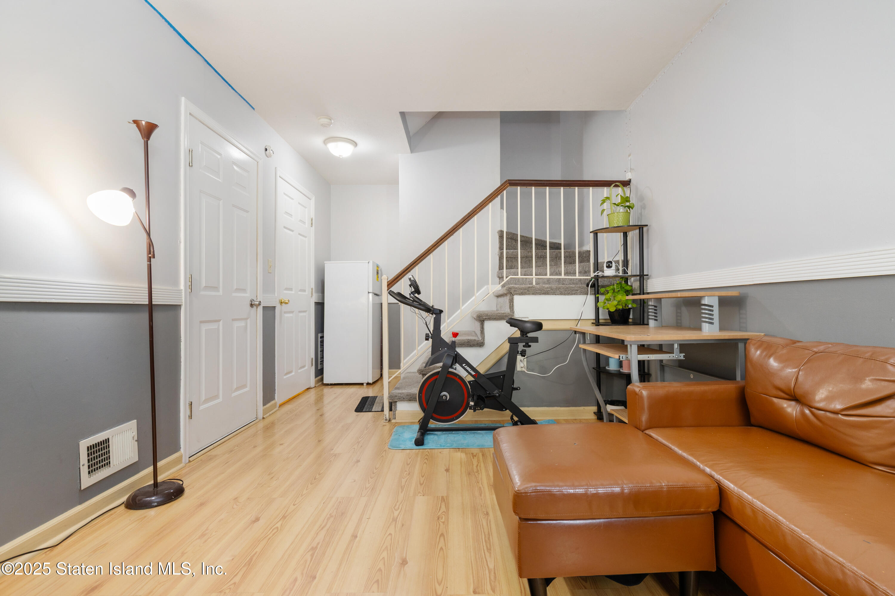263 Jamie Lane Staten Island, NY 10312 - Photo 9 of 44 a living room with a couch and a chandelier