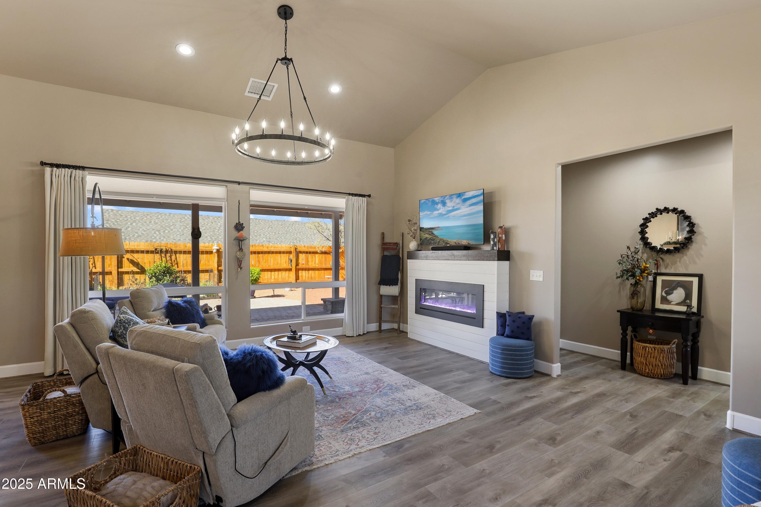 506 North Eagle Ridge Road Payson, AZ 85541 - Photo 25 of 41 a living room with fireplace furniture and a chandelier