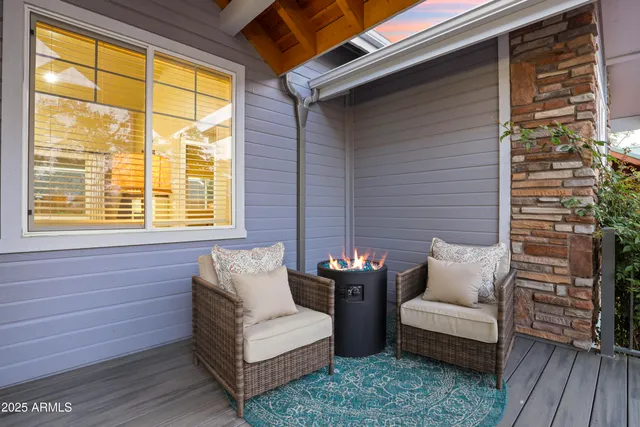 a view of a patio with couches and a dining table with wooden floor