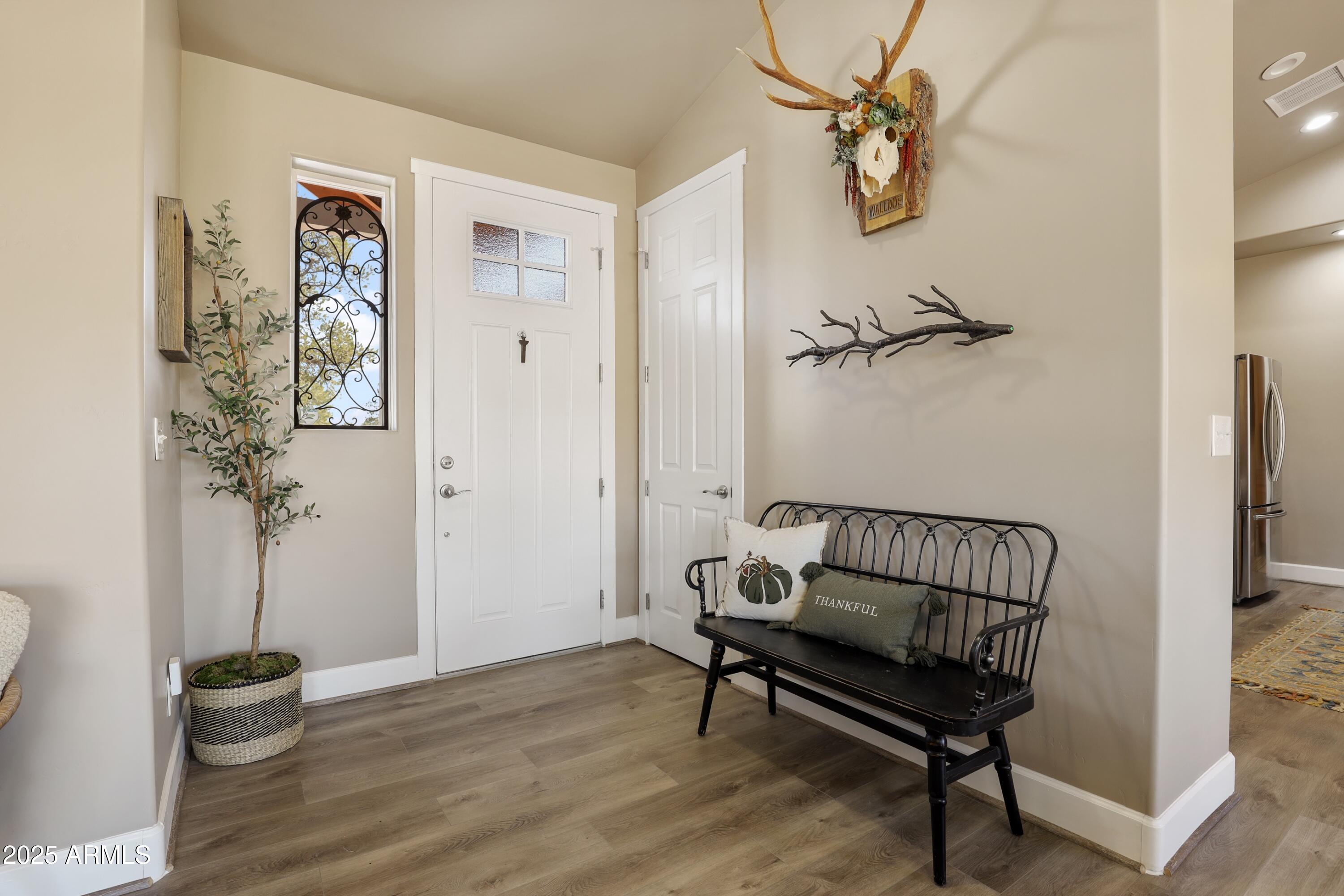 506 North Eagle Ridge Road Payson, AZ 85541 - Photo 4 of 41 a view of a hallway with wooden floor and a potted plant