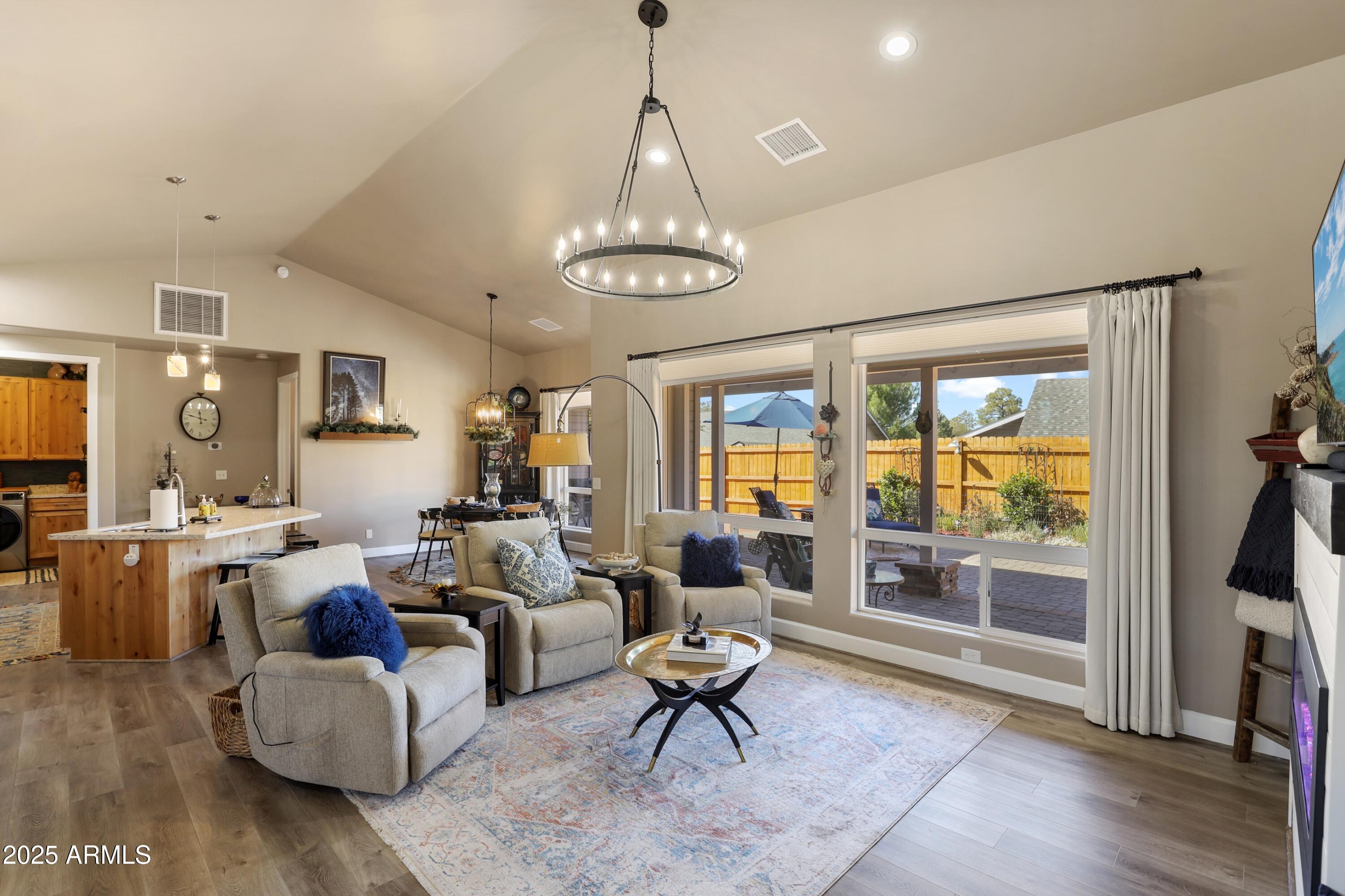 506 North Eagle Ridge Road Payson, AZ 85541 - Photo 8 of 41 a living room with furniture a chandelier and a dining table