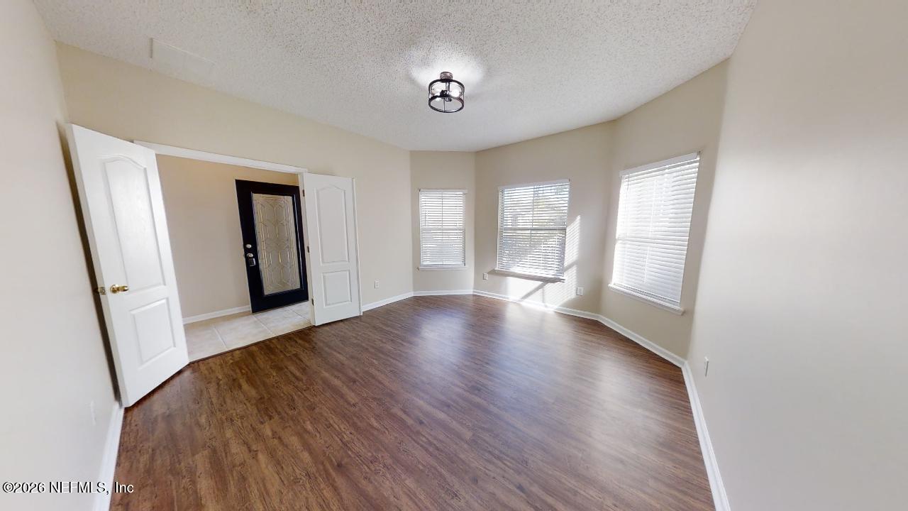 14454 Millhopper Road Jacksonville, FL 32258 - Photo 8 of 44 a view of livingroom with hardwood and front door