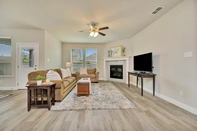 a living room with furniture fireplace and a flat screen tv