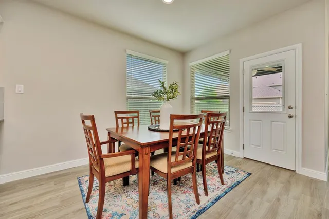 a dining room with furniture and window
