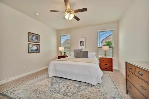 a bedroom with a large bed and a chandelier