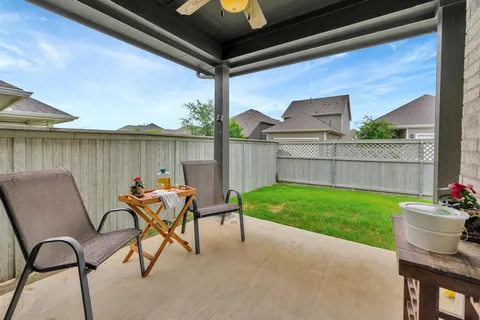 a backyard of a house with table and chairs