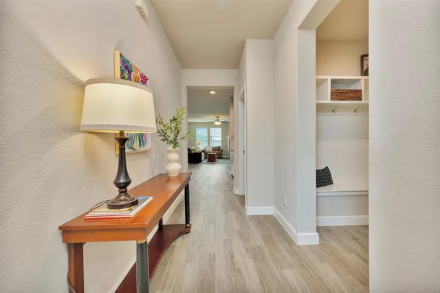 a view of a hallway with workspace and a mirror