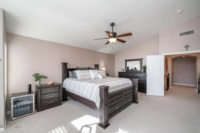 a bedroom with a bed and a chandelier
