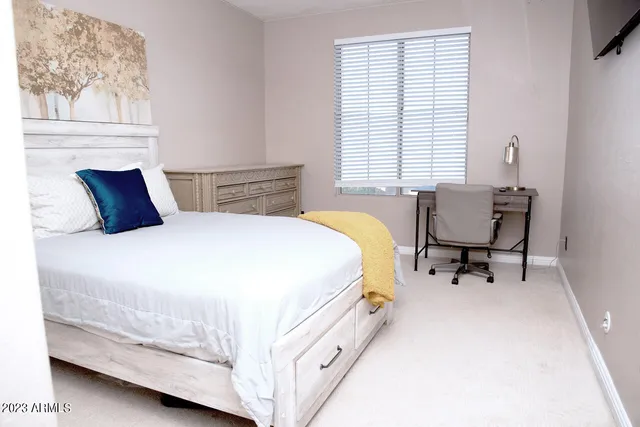 a bed room with a bed and chair