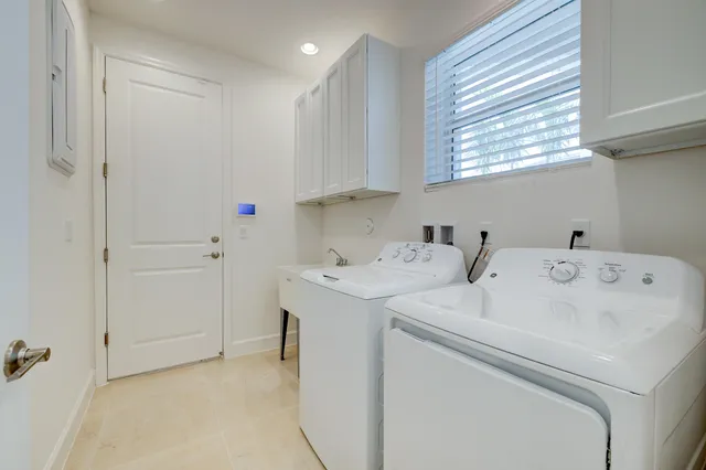 a living room with furniture a flat screen tv and kitchen view