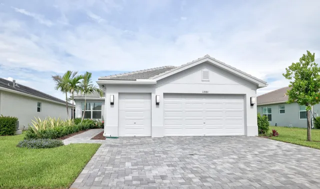 a view of a hallway with wooden floor and a bathroom