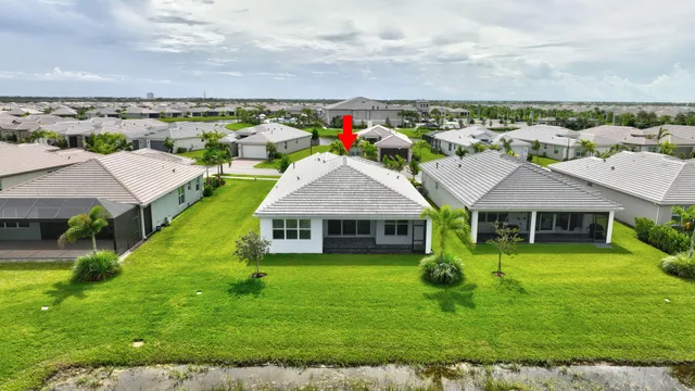 an aerial view of a house with swimming pool outdoor seating and yard