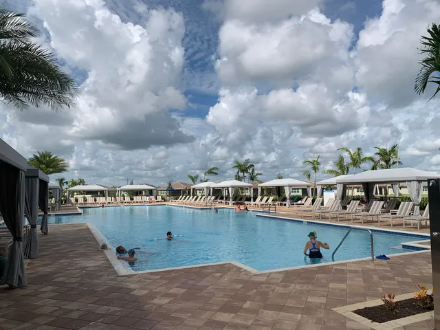 a living room with furniture a large window and a clock