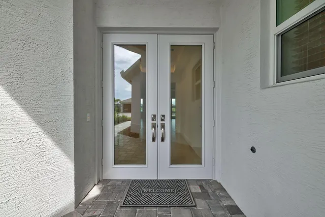 a view of a hallway with wooden floor and a hallway