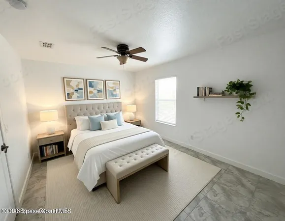a view of a room with a ceiling fan and window