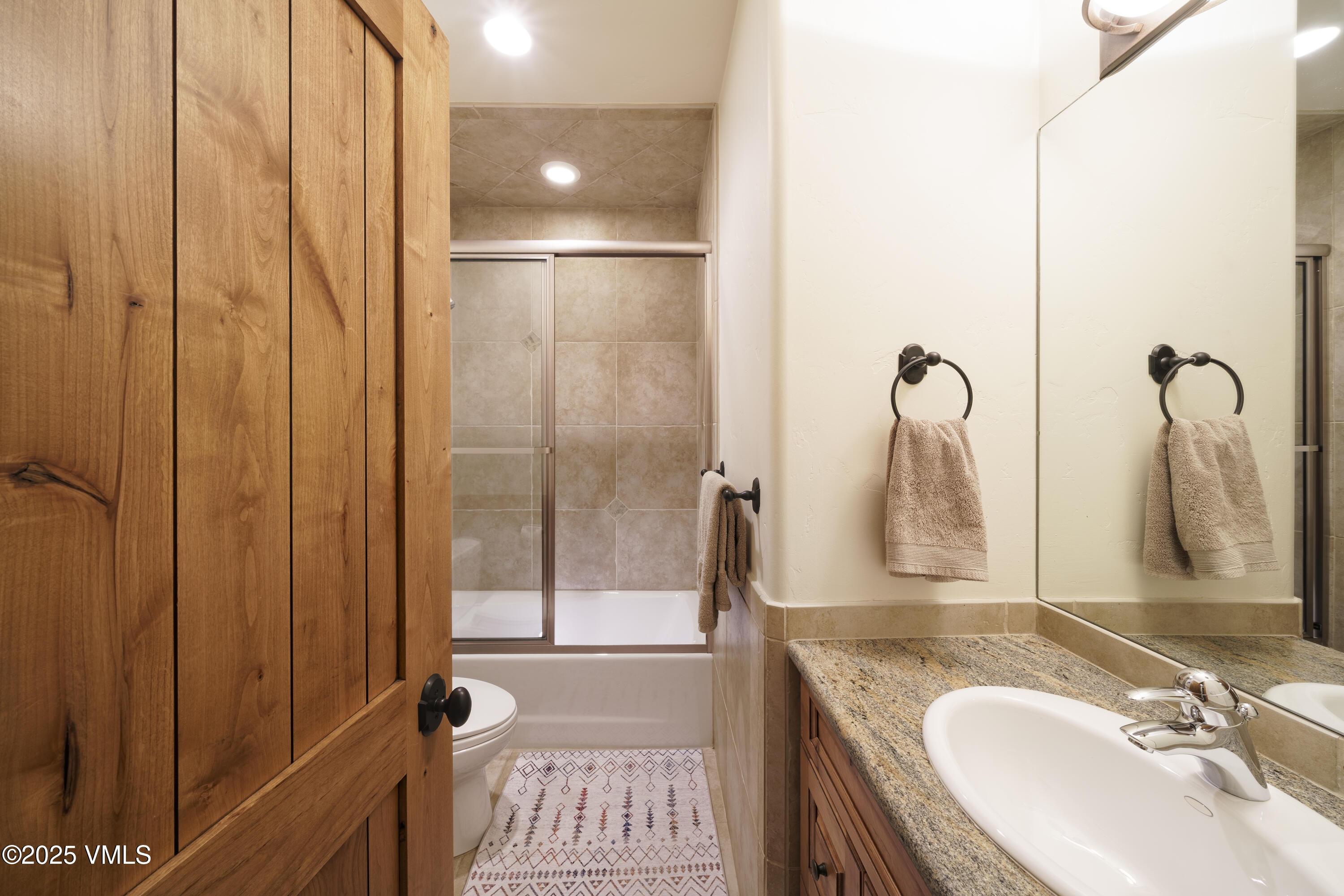 2735 Snowberry Drive, Unit B Vail, CO 81657 - Photo 24 of 48 a bathroom with a granite countertop sink and a mirror