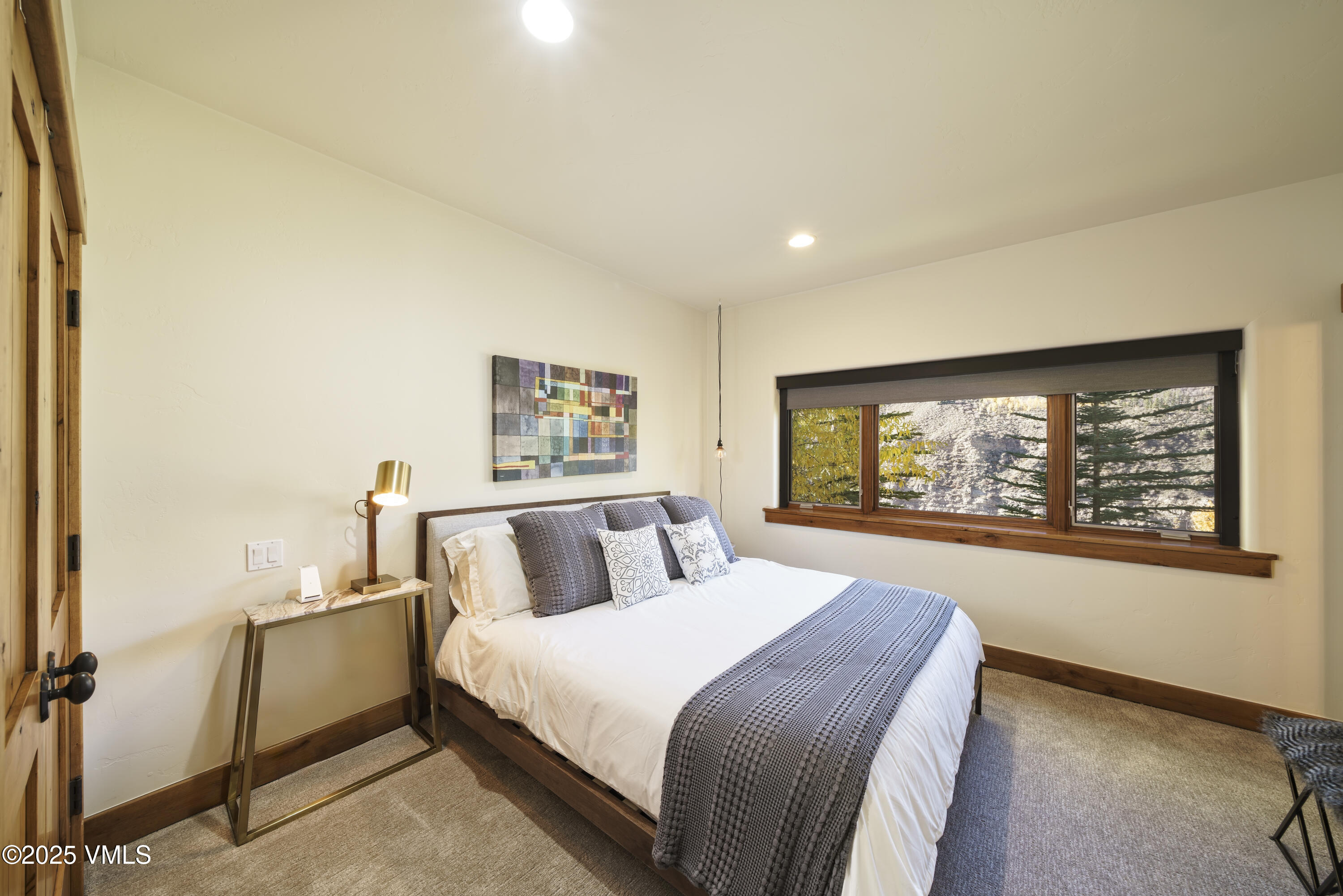 2735 Snowberry Drive, Unit B Vail, CO 81657 - Photo 27 of 48 a bedroom with a large bed and a window