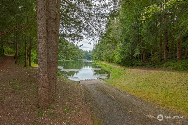 a view of backyard with swimming pool and outdoor seating