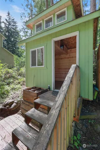 a view of a house with a yard and potted plants