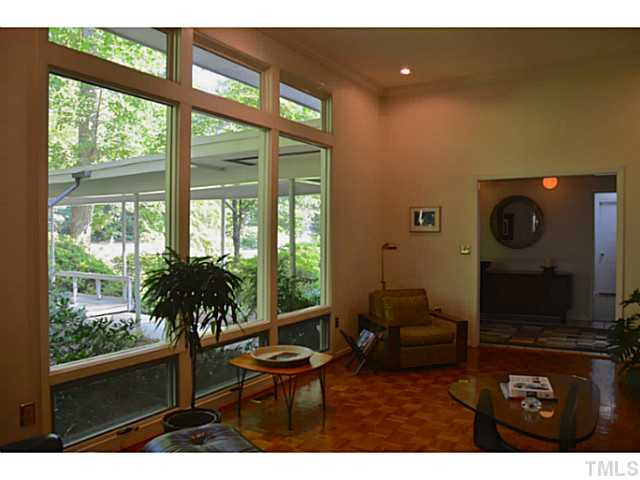 3700 Swann Street Raleigh, NC 27612 - Photo 4 of 20 Parquet floors and floor to ceiling windows can be found throughout the home, and are a very striking feature upon entry.