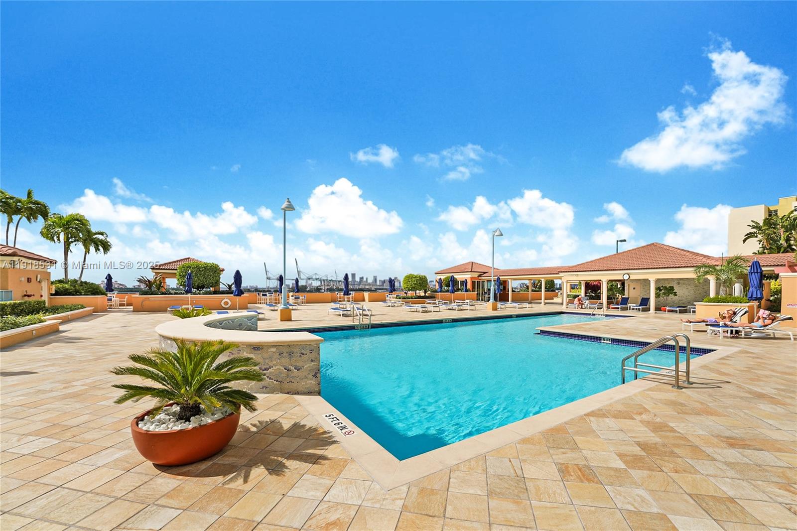 90 Alton Road, Unit 1209 Miami Beach, FL 33139 - Photo 11 of 44 a view of a swimming pool and lounge chair