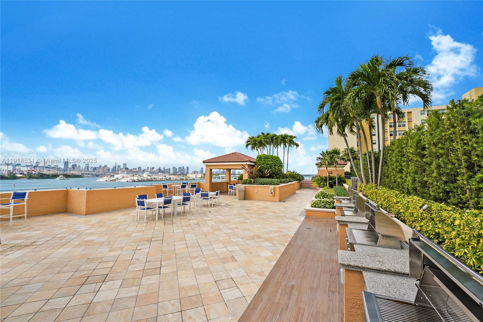 90 Alton Road, Unit 1209 Miami Beach, FL 33139 - Photo 13 of 44 a view of a swimming pool with an outdoor seating