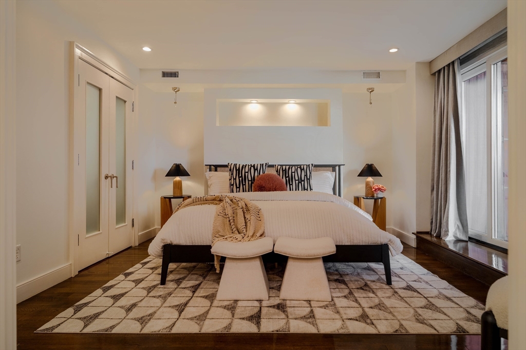 92 Waltham Street, Unit 1A Boston, MA 02118 - Photo 18 of 41 a bed sitting in a bedroom next to a window