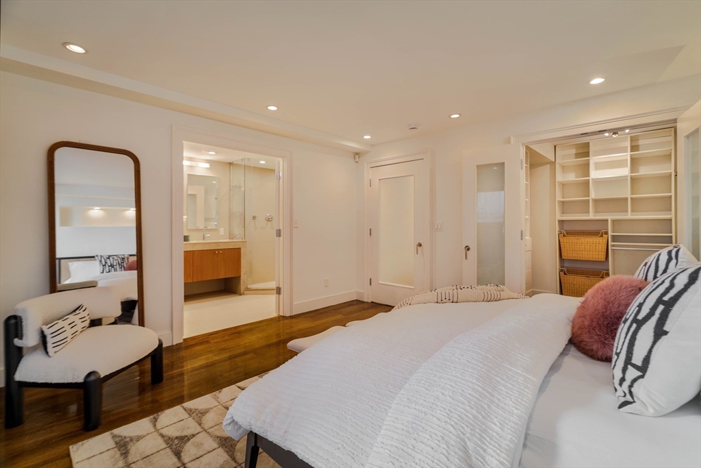 92 Waltham Street, Unit 1A Boston, MA 02118 - Photo 20 of 41 a spacious bedroom with a bed a couch and a dresser