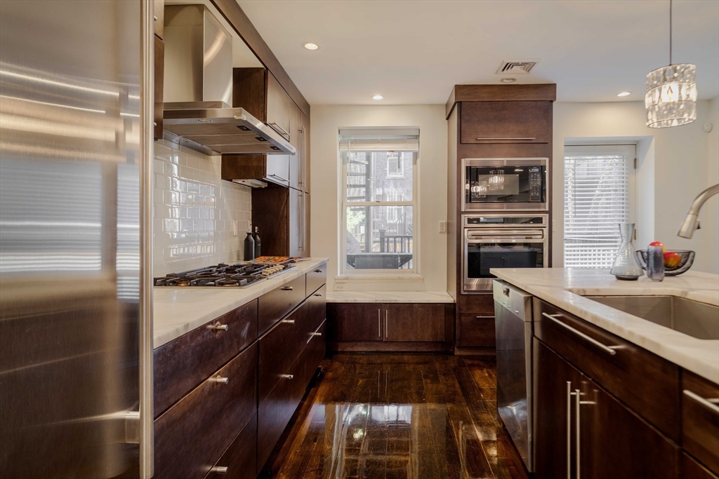 92 Waltham Street, Unit 1A Boston, MA 02118 - Photo 2 of 41 a kitchen with stainless steel appliances granite countertop a sink and a stove
