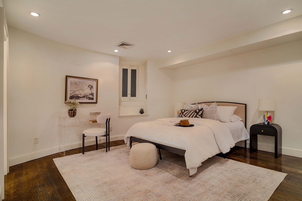 92 Waltham Street, Unit 1A Boston, MA 02118 - Photo 28 of 41 a bedroom with a bed and lamp