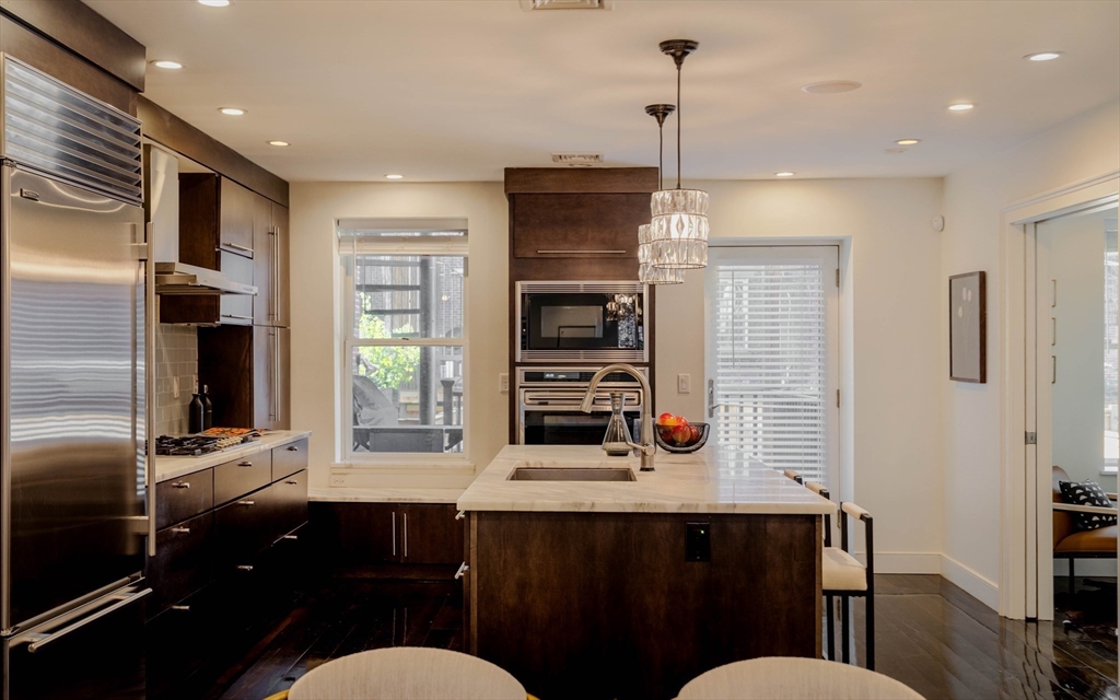 92 Waltham Street, Unit 1A Boston, MA 02118 - Photo 3 of 41 a kitchen with refrigerator and windows