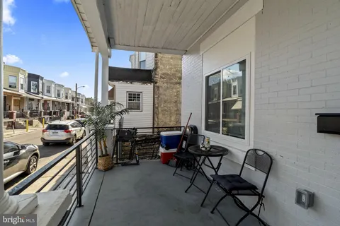 a view of a chairs and tables in the balcony