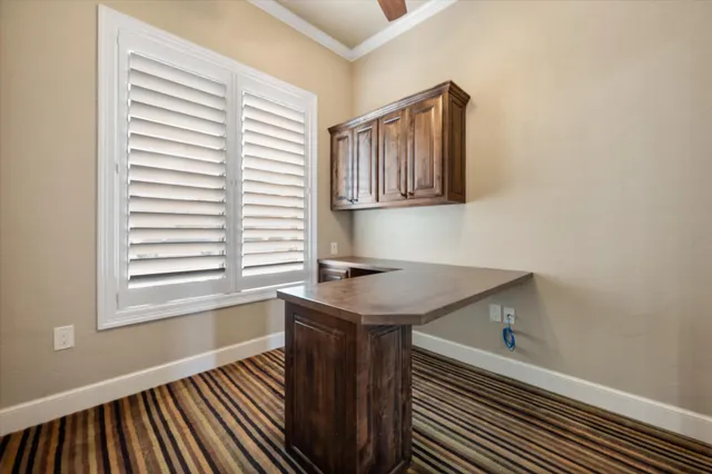 a kitchen with a sink cabinets and a window