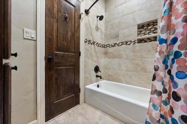 a bathroom with a bathtub and shower