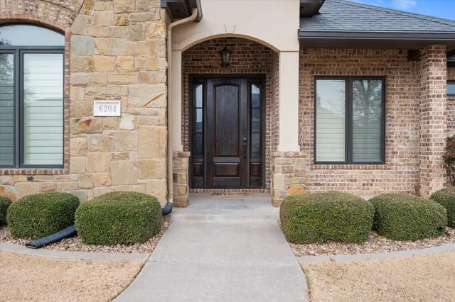 a front view of a house with a lots of windows