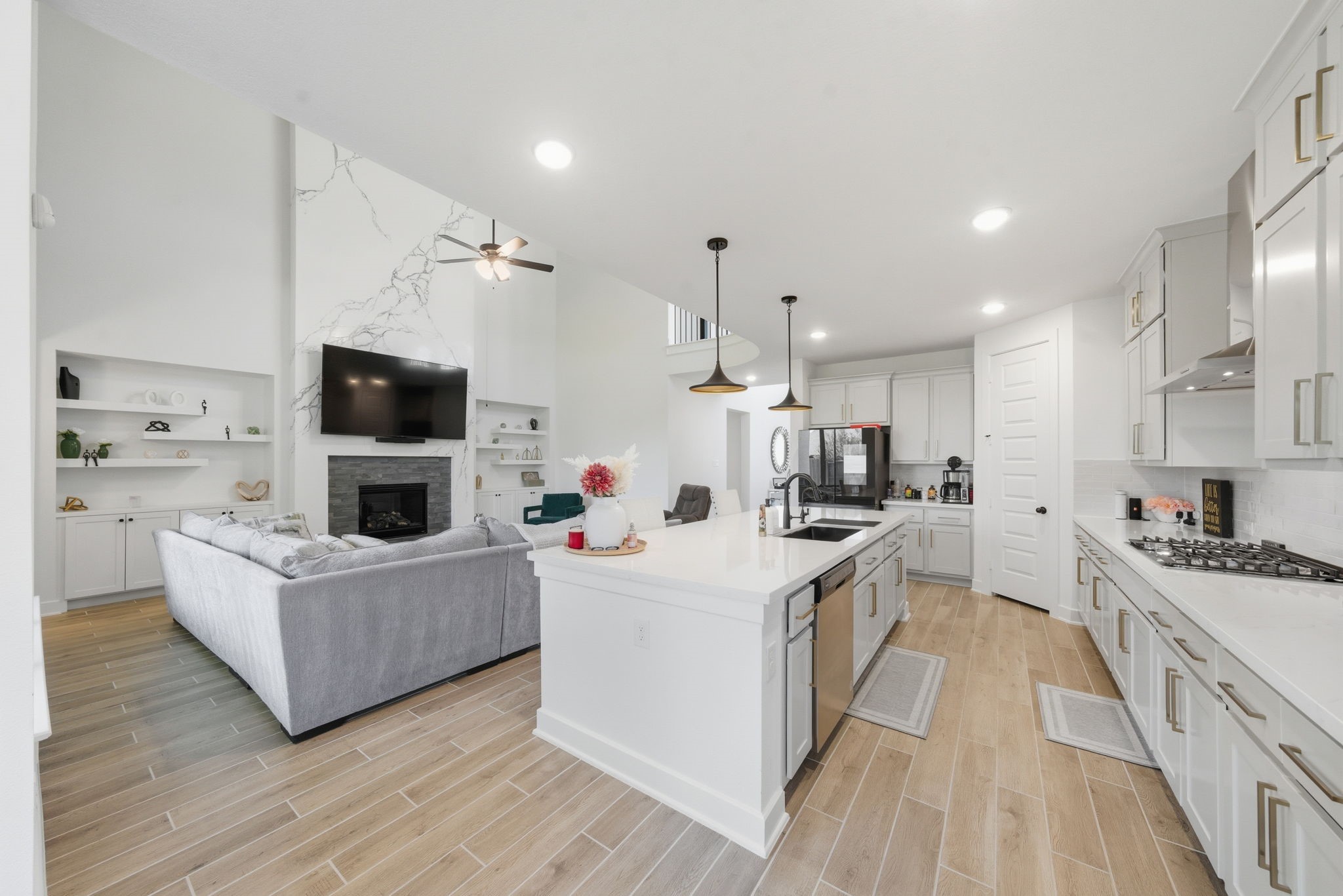 10438 Rigel Rdg Way Richmond, TX 77406 - Photo 13 of 34 a kitchen with kitchen island stainless steel appliances a sink a stove top oven a counter space and cabinets