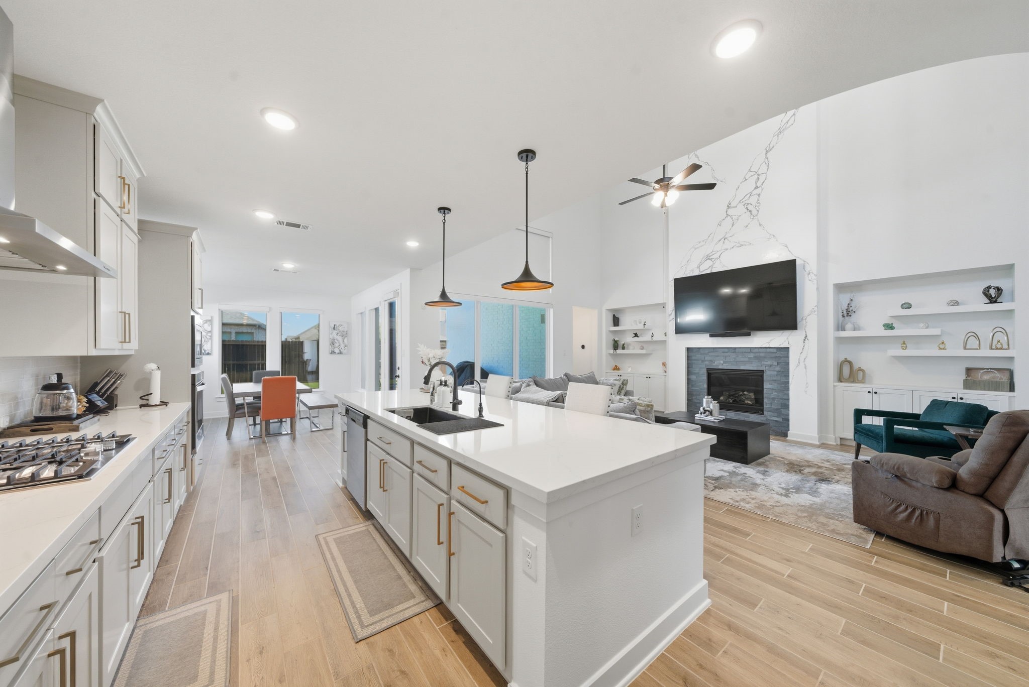 10438 Rigel Rdg Way Richmond, TX 77406 - Photo 14 of 34 a view of a kitchen with kitchen island a stove a sink a oven with a dining table and chairs