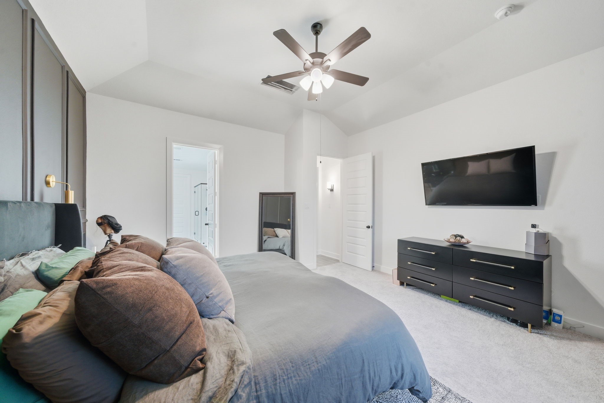 10438 Rigel Rdg Way Richmond, TX 77406 - Photo 20 of 34 a bedroom with a bed and a flat screen tv