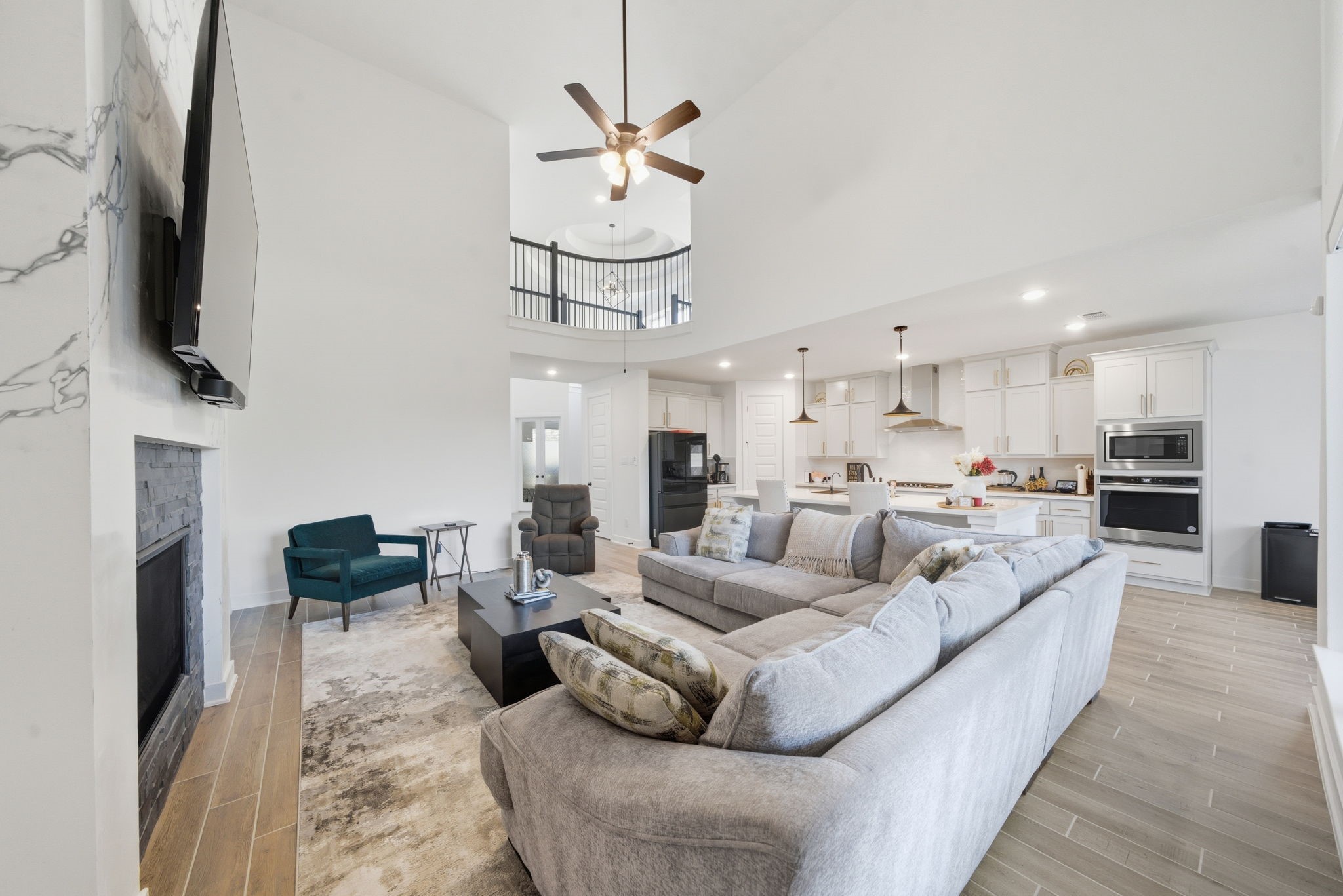 10438 Rigel Rdg Way Richmond, TX 77406 - Photo 8 of 34 a living room with furniture a flat screen tv and kitchen view